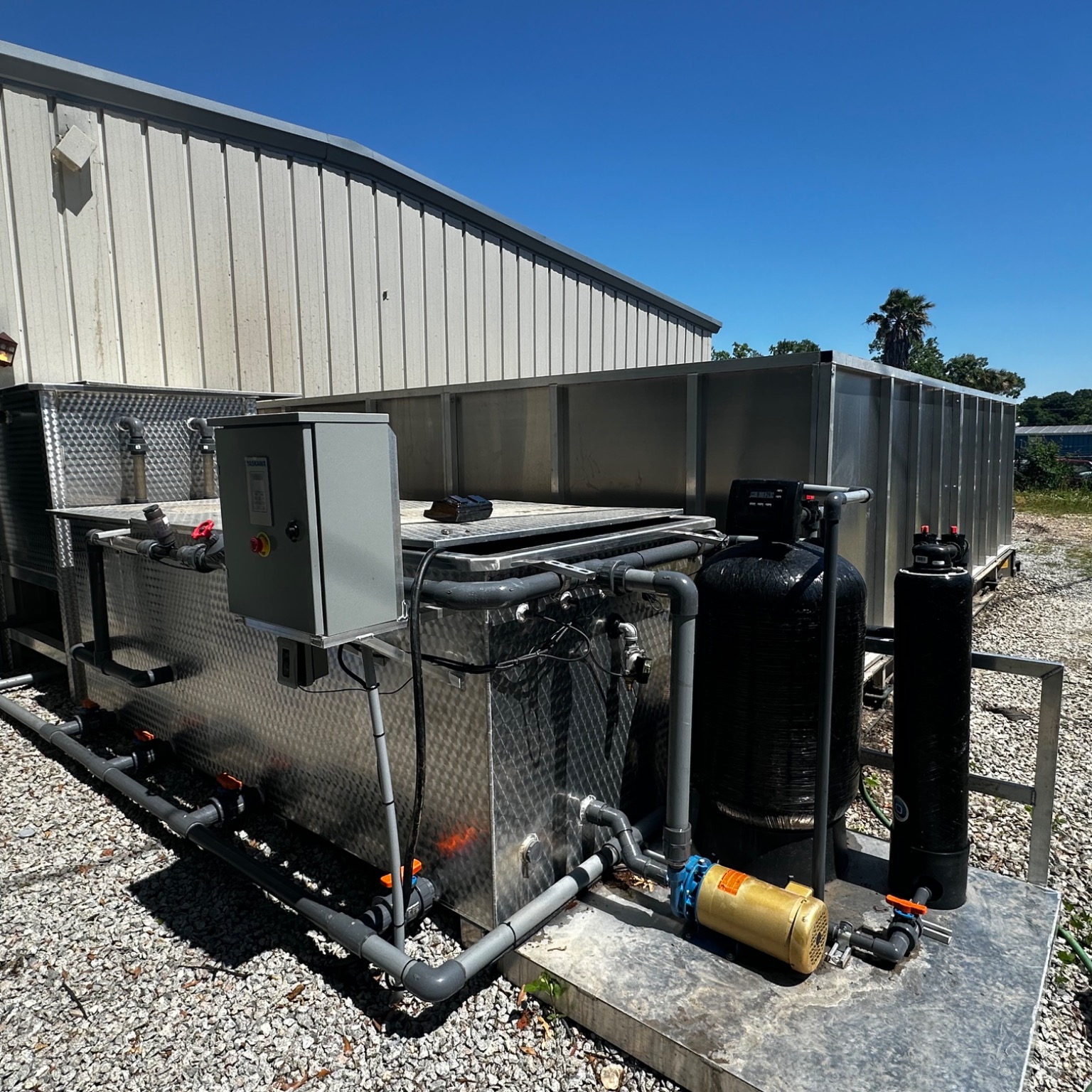 Wash water recycling system attached to portable wash pad.